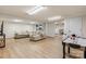 Finished basement area with a plush sectional sofa, built-in shelving, and an air hockey table at 4916 Leepers Creek Rd, Maiden, NC 28650