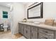 Bathroom features a light-colored countertop with gray cabinets and tile flooring, bathed in natural light at 4916 Leepers Creek Rd, Maiden, NC 28650