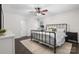 Relaxing bedroom features a dark metal bed frame, complemented by plush bedding and neutral-toned rug at 4916 Leepers Creek Rd, Maiden, NC 28650
