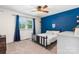 Vibrant bedroom boasting a blue accent wall, complemented by a modern bed frame and ample natural light at 4916 Leepers Creek Rd, Maiden, NC 28650