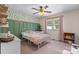 Inviting bedroom featuring a stylish wallpaper accent wall, a cozy bed, and soft pink accents at 4916 Leepers Creek Rd, Maiden, NC 28650