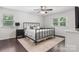 Relaxing bedroom with a dark metal bed frame, complemented by plush bedding and neutral-toned rug at 4916 Leepers Creek Rd, Maiden, NC 28650