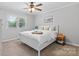 Serene bedroom with a white bed frame, matching nightstands, and a large window offering ample natural light at 4916 Leepers Creek Rd, Maiden, NC 28650