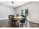 Bright dining area features a white dining table with 6 black chairs and access to the backyard at 4916 Leepers Creek Rd, Maiden, NC 28650