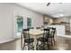 Bright dining area features a kitchen with a breakfast bar and backyard pool access through French doors at 4916 Leepers Creek Rd, Maiden, NC 28650