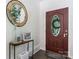 Inviting entryway features a decorative glass door and stylish console table with round mirror accent at 4916 Leepers Creek Rd, Maiden, NC 28650