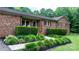 Charming brick home with neatly manicured bushes and verdant landscaping in the front yard at 4916 Leepers Creek Rd, Maiden, NC 28650