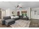 Comfortable living room with sectional sofa, area rug, and decorative accents by the entryway at 4916 Leepers Creek Rd, Maiden, NC 28650