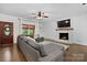 Spacious living room with a cozy fireplace, large sectional sofa, and natural light from the windows at 4916 Leepers Creek Rd, Maiden, NC 28650
