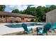 Relaxing pool area with lounge chairs, outdoor seating, a fire pit, and well-maintained landscaping at 4916 Leepers Creek Rd, Maiden, NC 28650