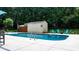 In-ground pool surrounded by a concrete patio, storage shed, and colorful Adirondack chairs at 4916 Leepers Creek Rd, Maiden, NC 28650