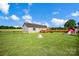 Large backyard featuring a stone fire pit, garden area, and fenced perimeter at 509 Brawley Rd # 7, Cleveland, NC 27013