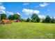 Spacious backyard with fire pit, garden area, and a cozy outdoor setting at 509 Brawley Rd # 7, Cleveland, NC 27013