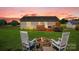 Picturesque backyard features a fire pit, rocking chairs, and a spacious wooden deck, perfect for outdoor enjoyment at 509 Brawley Rd # 7, Cleveland, NC 27013