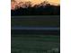 A view of land with a tree line at dusk, showing the topography and potential for future development at 509 Brawley Rd # 7, Cleveland, NC 27013