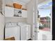 Well-lit laundry room with modern appliances and convenient storage cabinets, leading to a deck at 509 Brawley Rd # 7, Cleveland, NC 27013