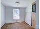 Cozy bedroom with hardwood floors, a window with blinds, and a neutral color scheme at 5604 Nc 152 E Hwy, Rockwell, NC 28138