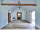 Spacious living room with exposed wood beam, fireplace, and natural light creates a warm atmosphere at 5604 Nc 152 E Hwy, Rockwell, NC 28138