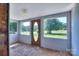 Bright sun room with multiple windows and an oval front door providing lots of natural light at 5604 Nc 152 E Hwy, Rockwell, NC 28138