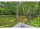 Overhead view of a lush backyard, featuring mature trees and a fire pit area at 5995 Tall Tree Ln, Harrisburg, NC 28075