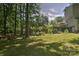 Expansive backyard featuring mature trees, perfect for outdoor activities at 5995 Tall Tree Ln, Harrisburg, NC 28075