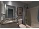 Cozy bathroom featuring a tub with shower, granite countertop, and decorative mirror at 5995 Tall Tree Ln, Harrisburg, NC 28075