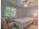 Charming bedroom with window and an accent chair, offers a pleasant and relaxing retreat within the home at 5995 Tall Tree Ln, Harrisburg, NC 28075