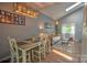 Open dining and living areas featuring modern lighting, hardwood floors, and comfortable seating at 5995 Tall Tree Ln, Harrisburg, NC 28075