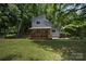 Charming home with a front porch and lush greenery, perfect for Gathering living at 5995 Tall Tree Ln, Harrisburg, NC 28075
