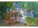 Charming two-story home with a covered wooden porch surrounded by lush trees at 5995 Tall Tree Ln, Harrisburg, NC 28075