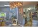 Open kitchen, dining, and living spaces with stainless appliances, hardwood floors, and ample storage at 5995 Tall Tree Ln, Harrisburg, NC 28075