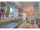 Modern kitchen with stainless steel appliances, granite countertops, and open shelves at 5995 Tall Tree Ln, Harrisburg, NC 28075