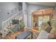Bright living room featuring hardwood floors, stairs to the second floor, and an open dining area at 5995 Tall Tree Ln, Harrisburg, NC 28075
