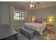Comfortable main bedroom with a ceiling fan and ample natural light creates a serene and welcoming atmosphere at 5995 Tall Tree Ln, Harrisburg, NC 28075
