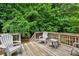 Wooden back deck with outdoor seating surrounded by mature trees for privacy at 605 Beavers Cove Nw Ln # 15, Concord, NC 28027