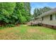 Lush backyard with a wooden deck, tall trees, and a wood fence at 605 Beavers Cove Nw Ln # 15, Concord, NC 28027