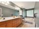 Double sink bathroom with wood cabinets, modern fixtures, and a large soaking tub at 605 Beavers Cove Nw Ln # 15, Concord, NC 28027