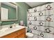 Bathroom features a penguin-themed shower curtain, mirror and modern sink at 605 Beavers Cove Nw Ln # 15, Concord, NC 28027