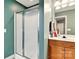 Bathroom featuring a glass enclosed shower and wooden vanity with modern sink at 605 Beavers Cove Nw Ln # 15, Concord, NC 28027