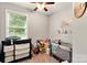 bedroom includes ceiling fan, changing table and baby furniture at 605 Beavers Cove Nw Ln # 15, Concord, NC 28027