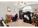 Bedroom with a ceiling fan, large window and sim racing rig at 605 Beavers Cove Nw Ln # 15, Concord, NC 28027