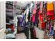 Walk-in closet providing ample storage with shelves and hanging racks filled with clothes at 605 Beavers Cove Nw Ln # 15, Concord, NC 28027