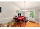 Dining room with natural light, hardwood floors, and red table setting at 605 Beavers Cove Nw Ln # 15, Concord, NC 28027