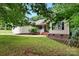 Charming home exterior featuring a well-manicured lawn and attached two-car garage at 605 Beavers Cove Nw Ln # 15, Concord, NC 28027