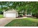Charming one-story home featuring a well-maintained lawn and attached two-car garage at 605 Beavers Cove Nw Ln # 15, Concord, NC 28027