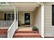Cozy front porch with brick stairs, white railing, and a 'Welcome' sign on the black screen door at 605 Beavers Cove Nw Ln # 15, Concord, NC 28027