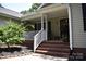 Inviting front porch with brick steps, white railing, and a charming, covered entrance at 605 Beavers Cove Nw Ln # 15, Concord, NC 28027