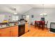 View of the open kitchen area with wood floors, oak cabinetry, and bar top seating at 605 Beavers Cove Nw Ln # 15, Concord, NC 28027