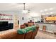 Open-concept living area with vaulted ceilings, ceiling fan, and a view of the kitchen at 605 Beavers Cove Nw Ln # 15, Concord, NC 28027