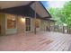 View of a spacious back deck with wood flooring, a door to the house, and a wooded view at 6227 Dogwood Ln, Waxhaw, NC 28173